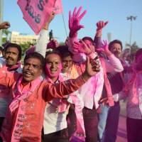 Supporters of the Telangana Rastra Samithi party shout slogans in Hyderabad, India, on Tuesday to celebrate the planned creation of the state of Telangana. Lawmakers in the lower house voted to pass a controversial bill creating what will be India\'s 29th state in New Delhi earlier in the day. | AFP-JIJI