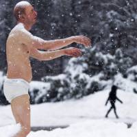A statue of a man sleepwalking in his underpants is surrounded by snow on the campus of Wellesley College, Massachusetts, on Wednesday. The statue, part of an exhibit by sculptor Tony Matelli, has stirred controversy, with some students at the all-women\'s school saying it triggers \"thoughts regarding sexual assault.\" | KYODO/REUTERS