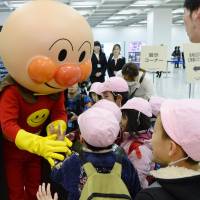 Children line up to meet beloved comic and anime character Anpanman, created by the late Takashi Yanase, at an event in Tokyo Thursday held to commemorate his work. | KYODO
