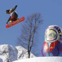 Snowboarder Yuki Kadono jumps near an outsized Russian matryoshka doll during a practice run ahead of the upcoming Winter Olympics in Sochi, Russia, on Monday. The competitions begin Thursday. | KYODO
