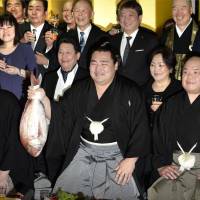 Kakuryu holds a sea bream to celebrate his promotion to sumo\'s highest rank of yokozuna. Kakuryu becomes the first new yokozuna since fellow Mongolian Harumafuji was promoted in 2012. | KYODO