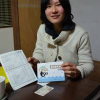 Member MikiSato shows her \"Una\" checkbook, named after unagi (eel), a local delicacy. | WINIFRED BIRD