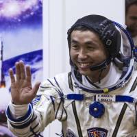 Japanese astronaut Koichi Wakata smiles during a spacesuit test before blasting off for the International Space Station from the Russian-leased Baikonur Cosmodrome in Kazakhstan last Nov. 6. | AFP-JIJI