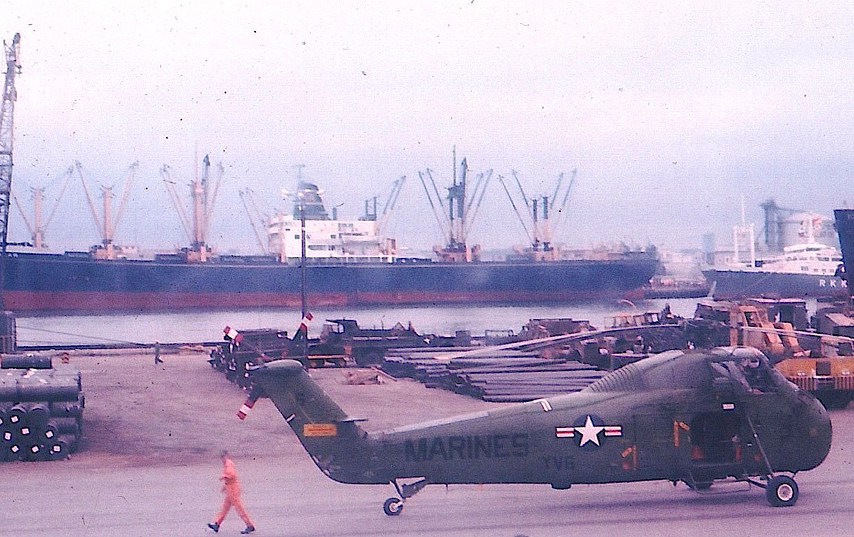 Loaded: A U.S. Marine Corps helicopter sits by unidentified barrels at Naha Military Port in the late '60s. | COURTESY OF MICHAEL JONES