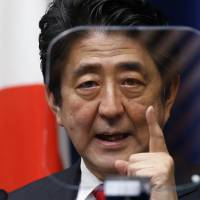 Prime Minister Shinzo Abe speaks while looking at a teleprompter during a news conference at his official residence Thursday. | AP