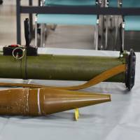 A Russian rocket launcher and a round found in 2012 in a Kitakyushu warehouse are displayed at a police station in Tagawa, Fukuoka Prefecture. | KYODO