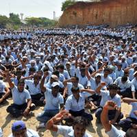 Workers at Toyota Kirloskar Motor shout pro-union slogans as they gather near its factory on the outskirts of Bangalore in India on Thursday. | AFP-JIJI