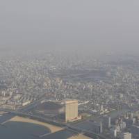 The sky above Fukuoka  Yafuoku Dome on the Fukuoka waterfront is clouded by yellow dust from China. | KYODO