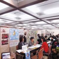 At a recent job fair, consultants from the Tokyo Metropolitan Government and the city of Fuchu, western Tokyo, advise people interested in working at nursery schools. Nursery school push hobbled by lack of workers