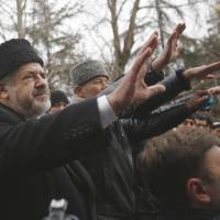Crimean Tatar leader Refat Chubarov addresses supporters during a protest in Simferopol, Ukraine, on Wednesday. | AP