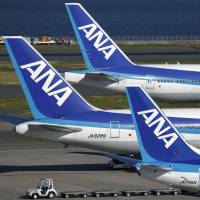 Part of All Nippon Airways Co.\'s fleet of passenger jets line the tarmac at Haneda airport in Tokyo in October. | BLOOMBERG