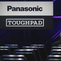 The logos of Panasonic Corp. and the company\'s Toughpad tablet are displayed prior to the unveiling event for the product in Tokyo on Feb. 24. | BLOOMBERG