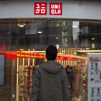 A shopper enters Fast Retailing Co.\'s Uniqlo Lee Theatre flagship store in Hong Kong on Jan. 27. | BLOOMBERG