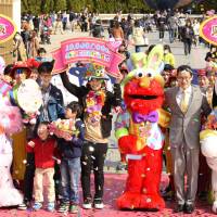 Yoshie Ishida (center) celebrates after being named visitor No. 10 million to Universal Studios Japan in Osaka on Wednesday. | KYODO
