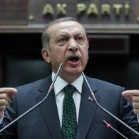 Turkish Prime Minister Recep Tayyip Erdogan addresses the members of his Islamic-rooted party in parliament in Ankara last June. | AP