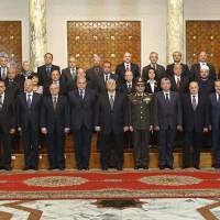 This image, released by the Egyptian Presidency on Saturday, shows interim President Adly Mansour (center), Field Marshal Abdel-Fattah el-Sissi (fifth right), and new interim Prime Minister Ibrahim Mehlib (fifth left), with the new cabinet ministers at the presidential palace in Cairo, Egypt. New Egypt Cabinet sworn in ahead of presidential vote