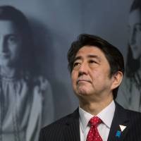 Prime Minister Shinzo Abe visits the Anne Frank House in Amsterdam on Sunday. Abe hails 'lessons of history' on visit to Anne Frank house