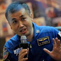 Japanese astronaut Koichi Wakata speaks behind a glass wall during a press conference at Kazakhstan’s Baikonur cosmodrome on Nov. 6, 2013. Wakata on Sunday became the first Japanese to serve as commander of the International Space Station. | AFP-JIJI