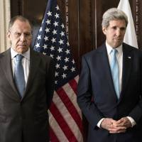 Russian Foreign Minister Sergey Lavrov (left) and U.S. Secretary of State John Kerry stand together before a meeting at Winfield House in London on Friday. | AFP-JIJI