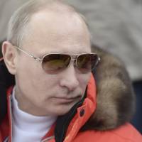 Russian President Vladimir Putin watches a skiing event at the Paralympic Winter Games at Rosa Khutor, near Sochi, Russia, on Sunday. | REUTERS