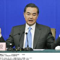 Chinese Foreign Minister Wang Yi gestures during a news conference Saturday in Beijing on the sidelines of the annual session of the National People\'s Congress, China\'s legislature. | KYODO