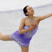 Reach out: Mao Asada performs her short program at the world championships at Saitama Super Arena on Thursday. Mao scored a world-record 78.66 points. | REUTERS