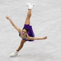 Purple prose: Akiko Suzuki performs her short-program routine at the world championships on Thursday. | REUTERS