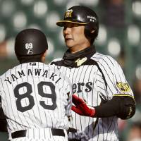 Early setback: The Tigers\' Ryota Arai (right) and his Hanshin teammates dropped a 6-2 home decision against the Chiba Lotte Marines on Friday in a preseason game. | KYODO