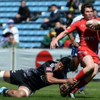 Nowhere to run: Wales\' Ross Thomas is tackled by New Zealand\'s Akira Ioane at the Tokyo Sevens on Saturday. | AFP-JIJI