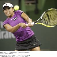 Another day at the office: Kurumi Nara hits a return to Allie Kiick in the first round of the BNP Paribas Open on Wednesday in Indian Wells, California. Nara advanced with a 6-4, 6-0 triumph. | KYODO