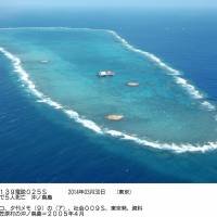 The tiny disputed outcroppings that represent Okinotorishima Island, an atoll some 1,700 km south of Tokyo and about 1,000 southeast of Okinawa, is shown April 2005 before high tide. | KYODO