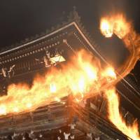 Torches light up Nigatsu-do, an important building at Todaiji Temple in the city of Nara, on Saturday. Ascetic monks carry torches in the annual Omizutori ritual heralding spring. | KYODO
