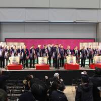 Participants in a previous Niigata Sakenojin make a toast to the crowd at the event. | LIBRARY