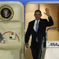 U.S. President Barack Obama steps out from Air Force One upon his arrival at Haneda International Airport in Tokyo on Wednesday, at the start of a four-nation trip to the region. | REUTERS