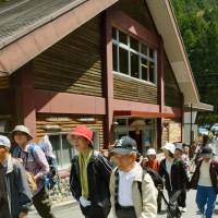 Hikers crowd a trail Friday in the Osugidani Valley of Mie Prefecture after it reopened to the public for the first time in 10 years after being ravaged by a typhoon. | KYODO