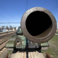A T-62 tank is prepared for shipment back to Ukraine from the Ostryakovo railway station near Simferopol, Crimea, on Monday, as Ukrainian forces pulled out of the region following its annexation by Russia. Yanukovych admits mistakes in first interview since his ouster