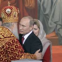 Russian Orthodox Patriarch Kirill congratulates President Vladimir Putin during a service for the celebration of the Orthodox Easter in Moscow on April 20. | AFP-JIJI