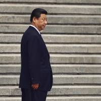 Chinese President Xi Jinping hosts a welcoming ceremony for Palestinian President Mahmoud Abbas outside the Great Hall of the People in Beijing in May 2013. By banishing corrupt senior officials, Xi is maneuvering close aides and reform-minded bureaucrats into key government and military positions to consolidate his grip on power and implement tough reforms. | REUTERS