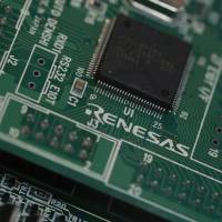 A photo from March 2013 shows a chip made by Renesas Electronics Corp. at the company\'s office in Tokyo. | REUTERS