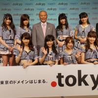 Tokyo Gov. Yoichi Masuzoe (back row, center), executives of GMO Registry Inc. (far left and far right), and members of idol group AKB48 attend a ceremony marking the debut of the Internet domain \".tokyo\" at a Tokyo hotel on Monday. | KAZUAKI NAGATA