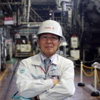 Mitsuru Kawai, senior technical executive at Toyota Motor Corp., poses in the forging department at one of the automaker\'s plants in Toyota, Aichi Prefecture, in February. | BLOOMBERG