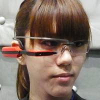 A model wears the \"inforod,\" a glasses-type information device unveiled by Japanese software maker Westunitis Co. in Osaka on Monday. | KYODO