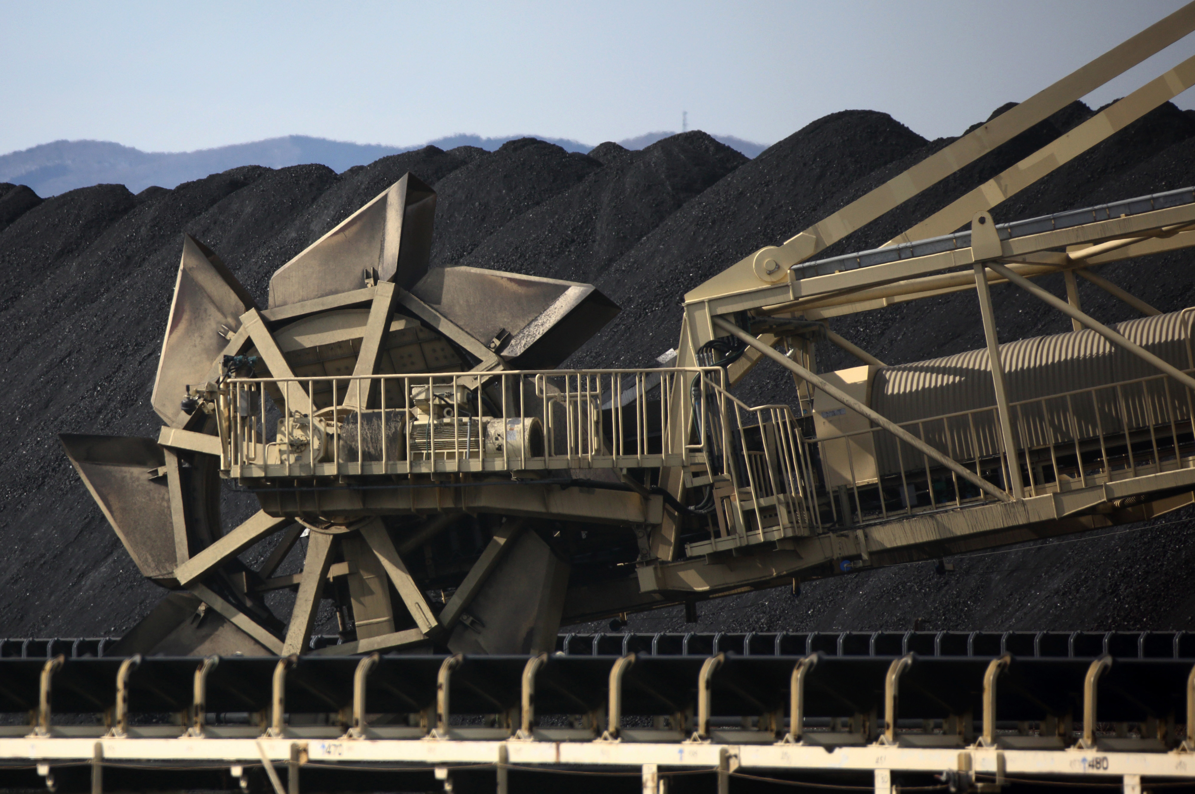 A bucket-wheel excavator moves coal at a stockpiling site at Onahama port in Iwaki, Fukushima Prefecture, in February. With the nation's nuclear power plants out of action, Japan now has to rely on oil-, coal- and gas-fired plants to replace more than 25 percent of its electricity needs lost since the multiple core meltdowns of March 2011. | BLOOMBERG