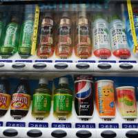 Soft drinks are shown in a Suntory Beverage vending machine in Tokyo in March. Higher prices risk 'Abenomics' backlash