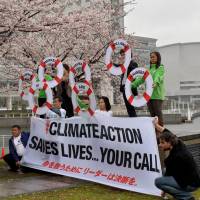 Environmental activists protest against global warming in Yokohama on March 30. | AFP-JIJI