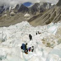 Climbers descend the Khumbu Icefall on their way back to Base Camo after summitting the 8,850-meter (29,035-foot) Mount Everest last May. The exodus from Everest