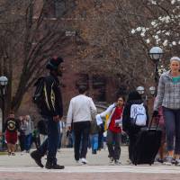 Students walk through the Ann Arbor campus of the University of Michigan on Tuesday. The same day, the U.S. Supreme Court upheld Michigan\'s ban on affirmative action, which was enacted by voters in 2006. | AP