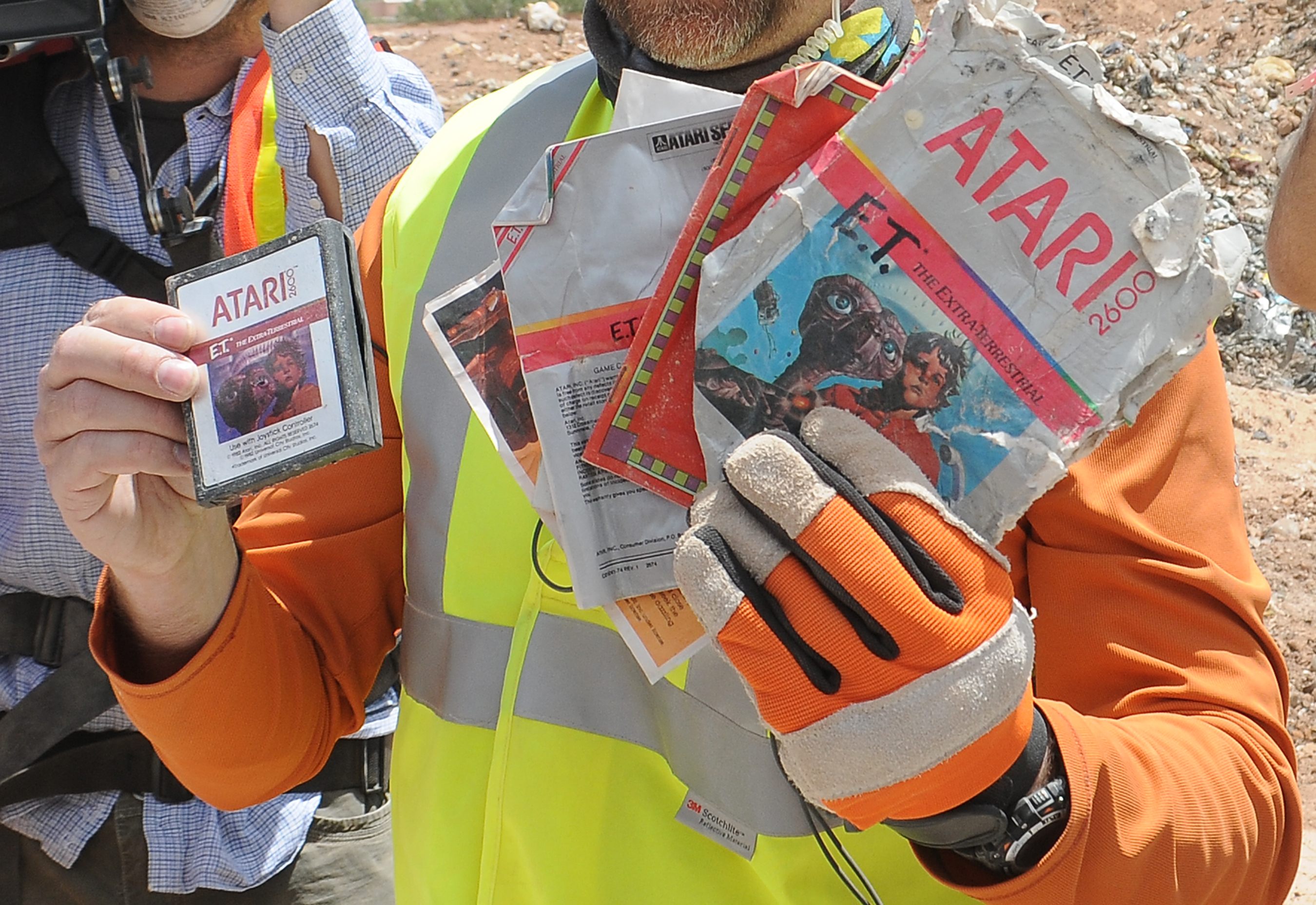 A worker shows the first recovered 'E.T. the Extra-Terrestrial' cartridge at the old Alamogordo landfill in New Mexico on Saturday. | REUTERS