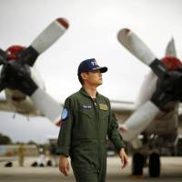Japan\'s Maritime Self-Defense Force Cmdr. Hidetsugu Iwamasa is pictured in front of one of the force\'s P-3C Orion aircraft currently at RAAF Base Pearce near Perth, Australia, on Friday. | REUTERS