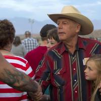Rancher Cliven Bundy (center) and his granddaughter greet supporters during a \"Patriot Party\" near Bunkerville, Nevada, on April 18. The Bundy family organized the event to thank people who supported the rancher in his dispute over grazing land with the Bureau of Land Management. | REUTERS